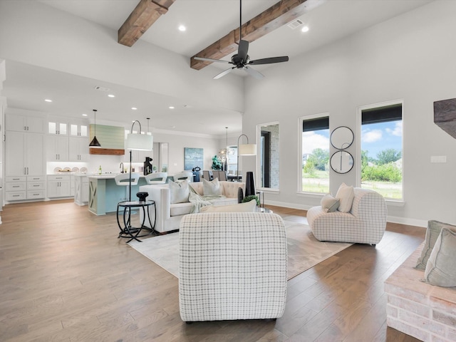 213 Martin Dr, Granbury, TX 76049 - living room with beam ceiling, light wood-style flooring, ceiling fan, baseboards, and recessed lighting