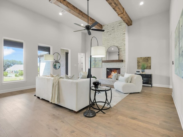 213 Martin Dr, Granbury, TX 76049 - living room with a towering ceiling, wood finished floors, baseboards, a brick fireplace, and beam ceiling