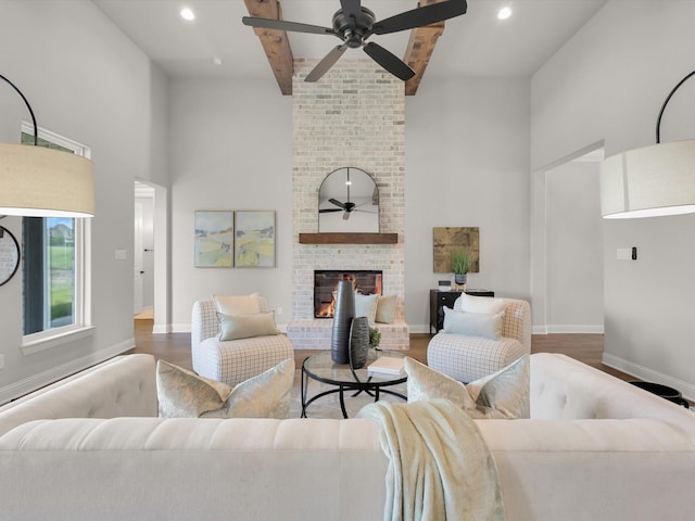 213 Martin Dr, Granbury, TX 76049 - living area featuring a high ceiling, ceiling fan, wood finished floors, a fireplace, and beamed ceiling