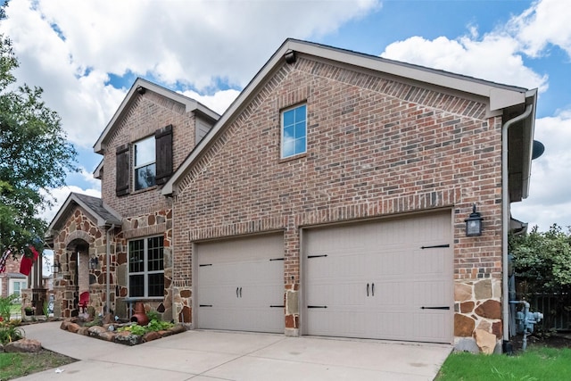 1036 Knoxbridge Rd, Forney, TX 75126 - view of front facade with brick siding, driveway, a garage, and stone siding