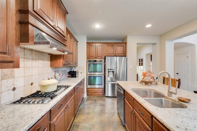 1036 Knoxbridge Rd, Forney, TX 75126 - kitchen featuring stainless steel appliances, brown cabinets, backsplash, ventilation hood, and recessed lighting