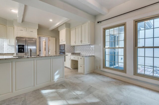 4713 N O Connor Ct, Irving, TX 75062 - kitchen featuring appliances with stainless steel finishes, beamed ceiling, a sink, light stone countertops, and backsplash