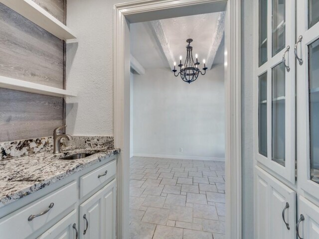 4713 N O Connor Ct, Irving, TX 75062 - bar area with a sink, a chandelier, and light stone finish floors