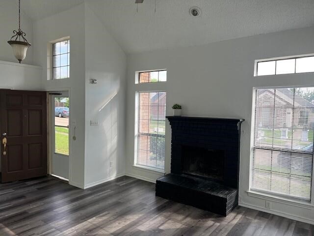 1737 Liberty Ln, Mesquite, TX 75149 - entryway featuring high vaulted ceiling, baseboards, dark wood-type flooring, and a fireplace with raised hearth