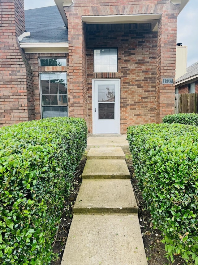 1737 Liberty Ln, Mesquite, TX 75149 - property entrance featuring brick siding and a shingled roof