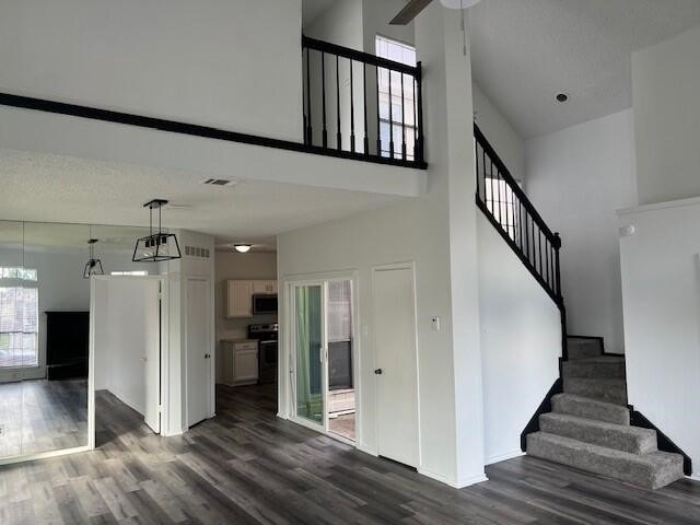 1737 Liberty Ln, Mesquite, TX 75149 - stairs with a high ceiling, wood finished floors, baseboards, and ceiling fan
