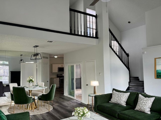 1737 Liberty Ln, Mesquite, TX 75149 - living area with dark wood finished floors, a high ceiling, stairway, a textured ceiling, and a ceiling fan