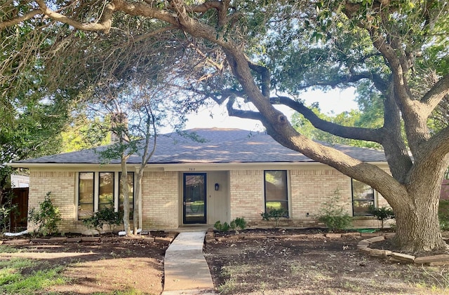 2512 Lawndale Dr, Plano, TX 75023 - view of front of house featuring brick siding and roof with shingles