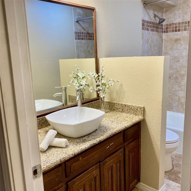 2512 Lawndale Dr, Plano, TX 75023 - full bathroom featuring vanity, toilet, washtub / shower combination, and a textured wall