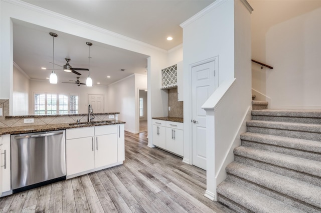 393 Bluebird Ln, Fairview, TX 75069 - kitchen with stainless steel dishwasher, a sink, tasteful backsplash, white cabinetry, and crown molding