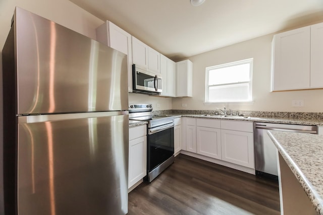 471 Bobbie St, Mabank, TX 75147 - kitchen featuring stainless steel appliances, white cabinets, a sink, dark wood-style flooring, and light stone countertops