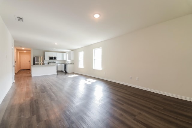 471 Bobbie St, Mabank, TX 75147 - unfurnished living room featuring baseboards, dark wood-style floors, and recessed lighting