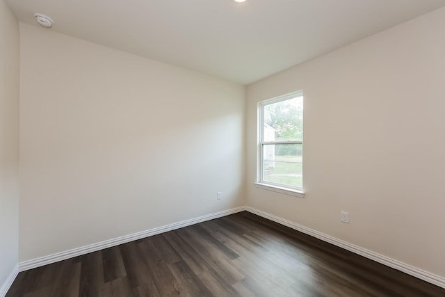 825 Garrison St, Waco, TX 76704 - unfurnished room with dark wood finished floors, a smoke detector, baseboards, and recessed lighting