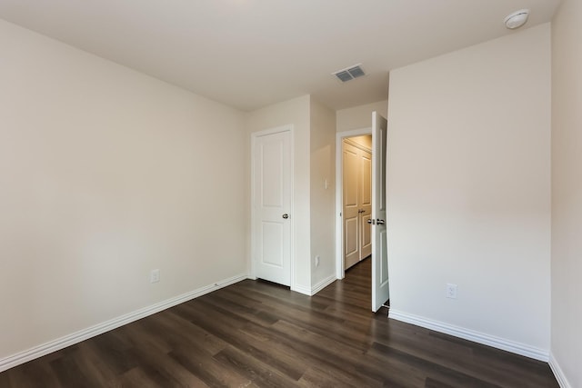 825 Garrison St, Waco, TX 76704 - unfurnished bedroom with dark wood-style floors and baseboards