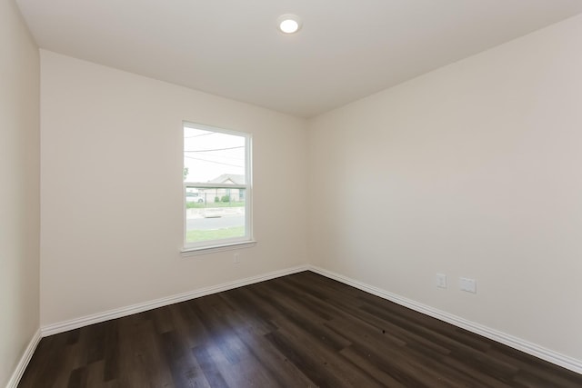 825 Garrison St, Waco, TX 76704 - empty room with dark wood-style flooring, baseboards, and recessed lighting