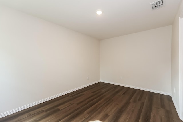 825 Garrison St, Waco, TX 76704 - spare room with baseboards, dark wood-type flooring, and recessed lighting