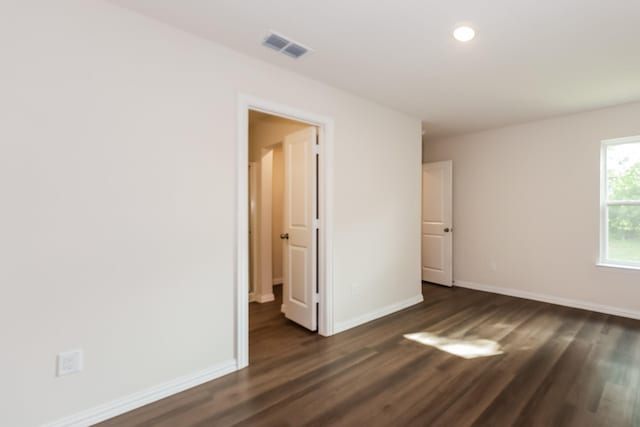 825 Garrison St, Waco, TX 76704 - unfurnished bedroom with dark wood finished floors, baseboards, and recessed lighting