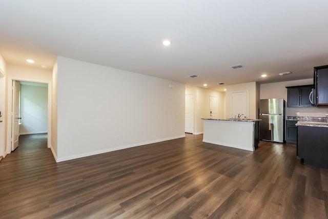 825 Garrison St, Waco, TX 76704 - unfurnished living room featuring dark wood finished floors, recessed lighting, and baseboards