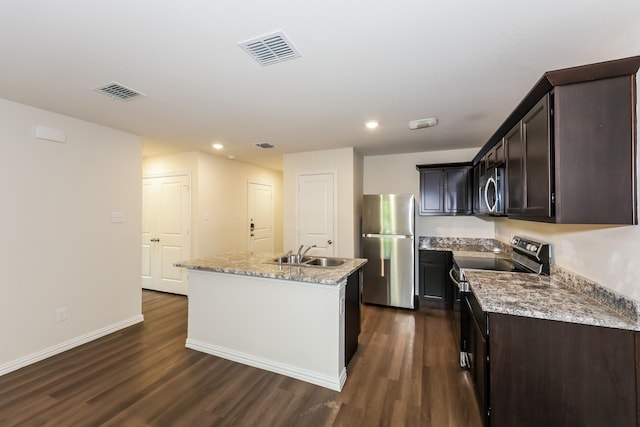825 Garrison St, Waco, TX 76704 - kitchen with stainless steel appliances, a sink, dark wood-type flooring, an island with sink, and dark brown cabinets
