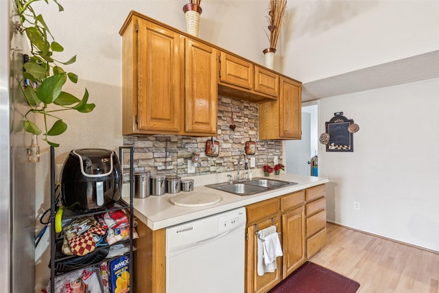 1005 Blue Jay Dr, Mansfield, TX 76063 - kitchen featuring white dishwasher, backsplash, light countertops, and light wood-type flooring