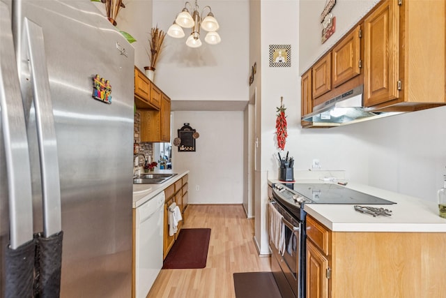 1005 Blue Jay Dr, Mansfield, TX 76063 - kitchen with freestanding refrigerator, black electric range oven, dishwasher, light wood-style floors, and under cabinet range hood