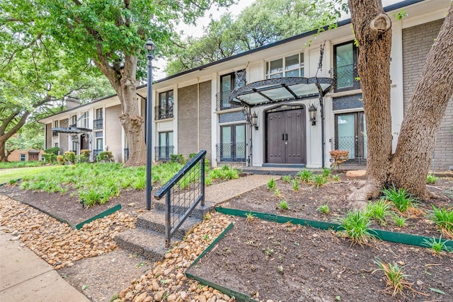 10203 Regal Oaks Dr Unit 202, Dallas, TX 75230 - view of front of home with brick siding and french doors