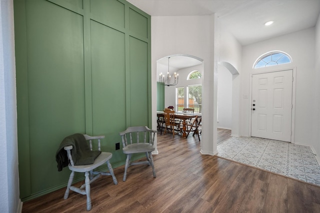 800 Bur Oak Dr, Burleson, TX 76028 - foyer with a chandelier, arched walkways, and dark wood finished floors