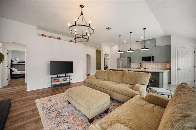 800 Bur Oak Dr, Burleson, TX 76028 - living room featuring arched walkways, dark wood-style floors, a chandelier, vaulted ceiling, and recessed lighting