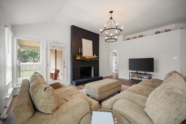 800 Bur Oak Dr, Burleson, TX 76028 - living room featuring arched walkways, a chandelier, light wood-type flooring, vaulted ceiling, and a large fireplace