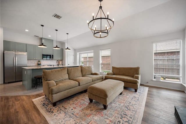 800 Bur Oak Dr, Burleson, TX 76028 - living room with vaulted ceiling, a chandelier, light wood-type flooring, and recessed lighting