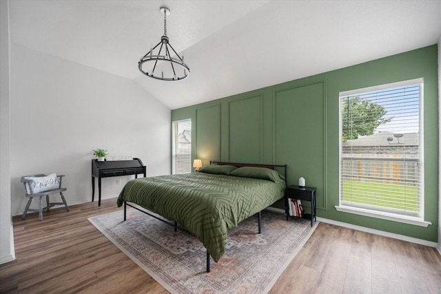 800 Bur Oak Dr, Burleson, TX 76028 - bedroom featuring wood finished floors, lofted ceiling, a decorative wall, and baseboards