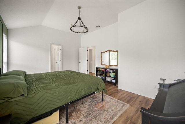 800 Bur Oak Dr, Burleson, TX 76028 - bedroom featuring lofted ceiling, dark wood finished floors, baseboards, and a chandelier