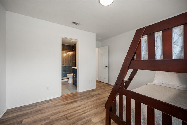 800 Bur Oak Dr, Burleson, TX 76028 - bedroom featuring wood finished floors, baseboards, and connected bathroom