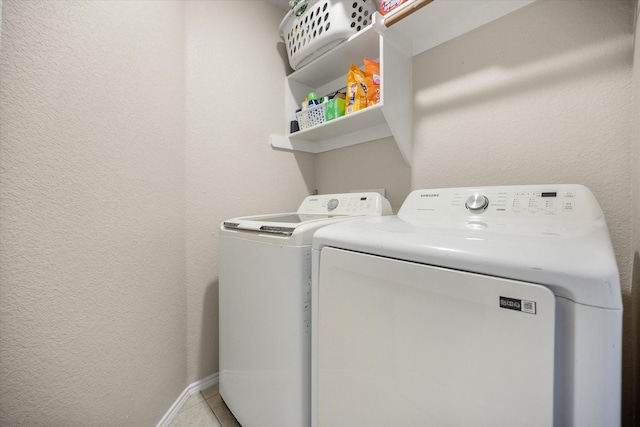 800 Bur Oak Dr, Burleson, TX 76028 - laundry area featuring washer and clothes dryer, a textured wall, and baseboards