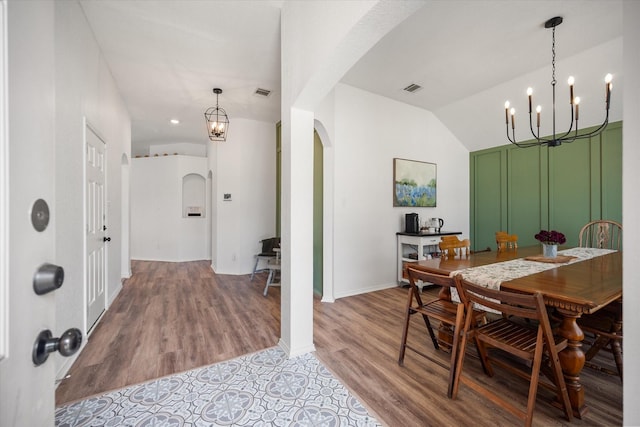 800 Bur Oak Dr, Burleson, TX 76028 - dining area with arched walkways, a chandelier, light wood-style floors, lofted ceiling, and baseboards