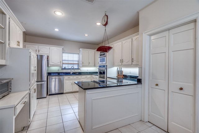 813 Singing Hills Dr, Garland, TX 75044 - kitchen featuring appliances with stainless steel finishes, a sink, light tile patterned floors, white cabinets, and dark countertops