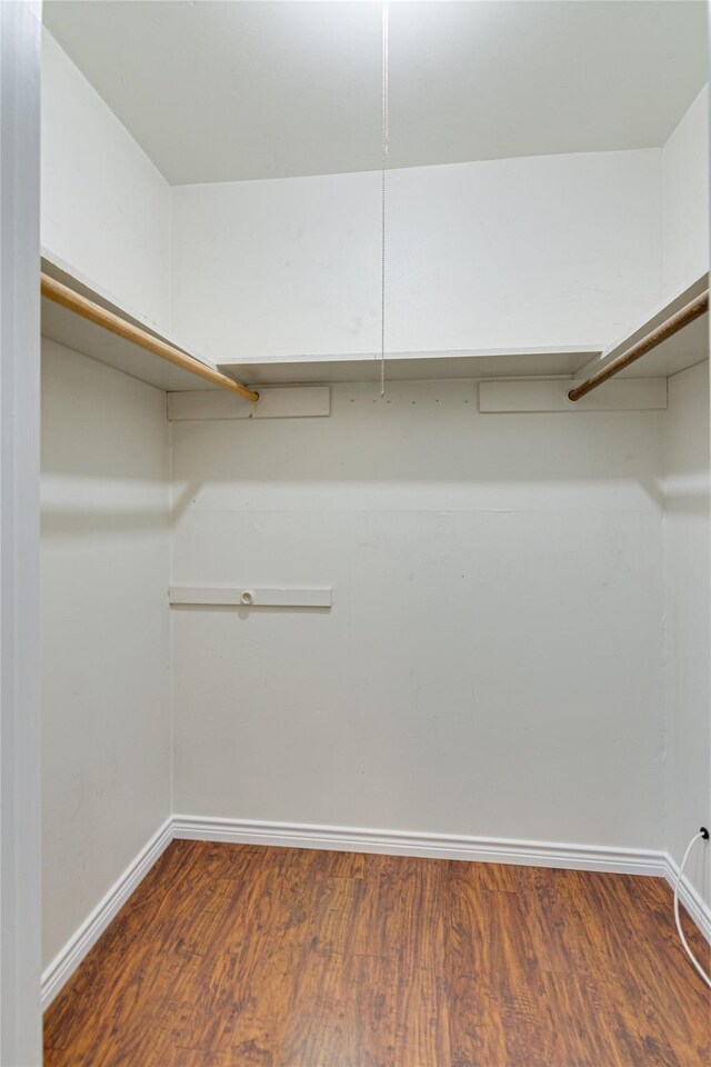 4501 Mink Dr, Haltom City, TX 76117 - walk in closet featuring wood finished floors