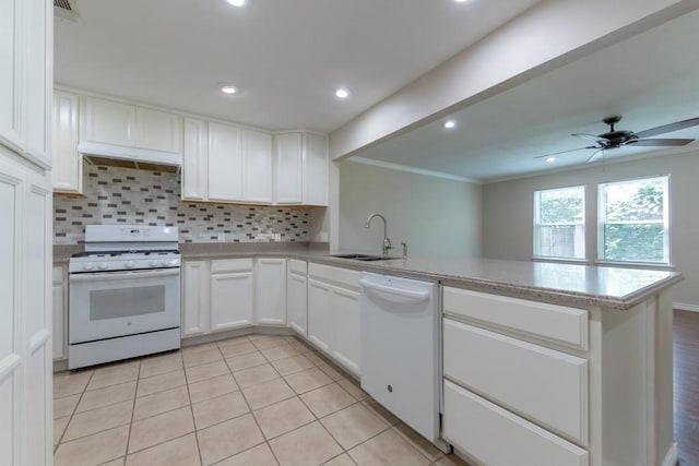 4501 Mink Dr, Haltom City, TX 76117 - kitchen with white appliances, a sink, a peninsula, crown molding, and tasteful backsplash