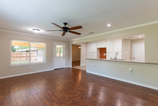 4501 Mink Dr, Haltom City, TX 76117 - unfurnished living room with a ceiling fan, a sink, wood finished floors, ornamental molding, and baseboards