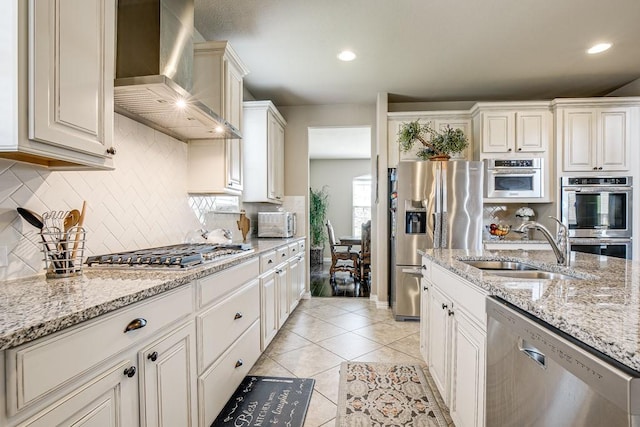 371 Ash Brook Ln, Sunnyvale, TX 75182 - kitchen featuring wall chimney exhaust hood, appliances with stainless steel finishes, a sink, decorative backsplash, and light tile patterned flooring