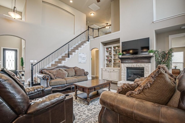 371 Ash Brook Ln, Sunnyvale, TX 75182 - living room with a towering ceiling, arched walkways, a fireplace, built in features, and ceiling fan