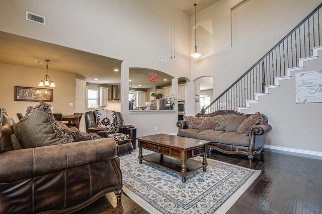 371 Ash Brook Ln, Sunnyvale, TX 75182 - living area with a towering ceiling, dark wood-style floors, arched walkways, baseboards, and stairs