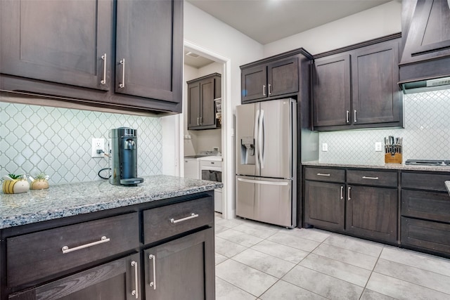 1225 Horsemint Dr, Little Elm, TX 75068 - kitchen featuring stainless steel fridge, washer and clothes dryer, dark brown cabinets, and tasteful backsplash