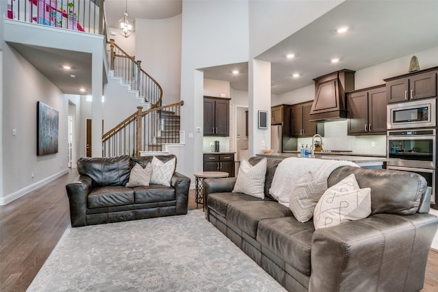 1225 Horsemint Dr, Little Elm, TX 75068 - living area featuring a high ceiling, wood finished floors, stairway, baseboards, and recessed lighting