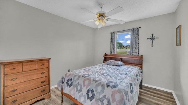 239 N 10th St, Jacksboro, TX 76458 - bedroom with baseboards, light wood-type flooring, and a ceiling fan