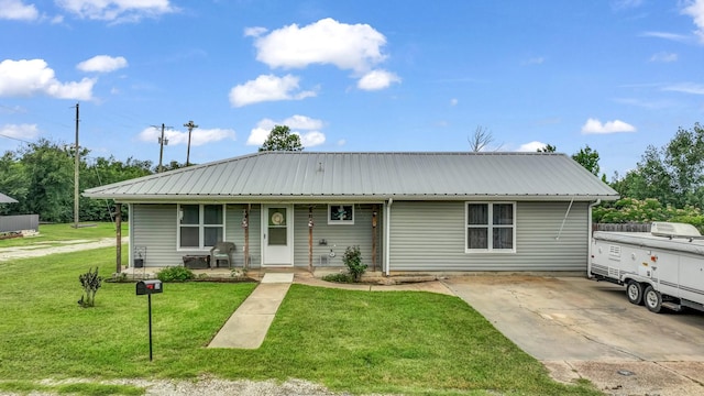 239 N 10th St, Jacksboro, TX 76458 - view of front of home featuring covered porch, metal roof, and a front lawn