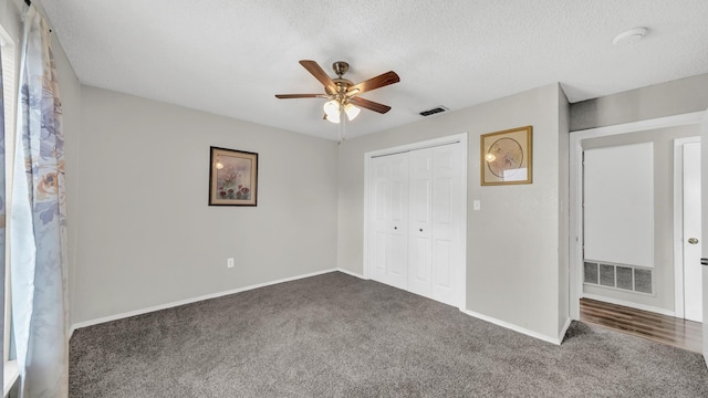 239 N 10th St, Jacksboro, TX 76458 - unfurnished bedroom with dark colored carpet, baseboards, a closet, and a textured ceiling