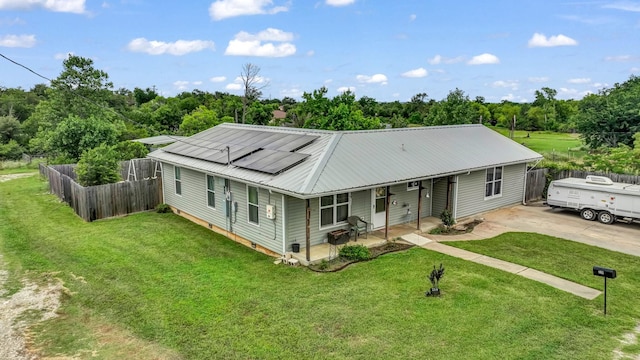 239 N 10th St, Jacksboro, TX 76458 - view of front of property featuring metal roof, solar panels, and concrete driveway