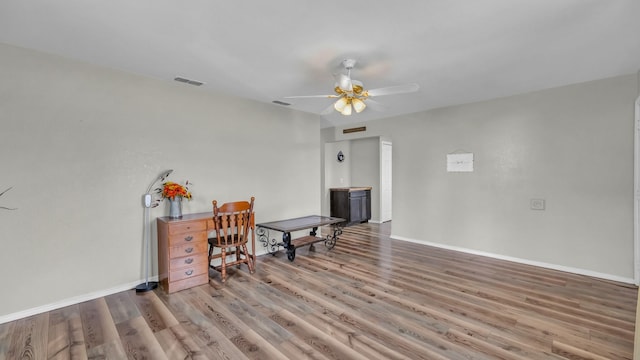 239 N 10th St, Jacksboro, TX 76458 - living area with ceiling fan, wood finished floors, and baseboards