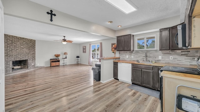239 N 10th St, Jacksboro, TX 76458 - kitchen featuring stainless steel appliances, a sink, wooden counters, tasteful backsplash, and a textured ceiling